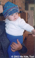 This adorable baby is wearing a new warm hat, thanks to L.E. Knisley of Ft. Walton Beach, FL, and the beautiful sweater, thanks