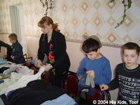 Volunteer Sasha sorts clothing for distribution to the waiting orphans.