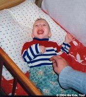 Aloysha, a CP child, waits for parents.  He laughs when tickled!
