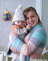 This little one loves her new hat, toys and clothes.