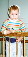 This little boy is sad that they won't let him out of this crib.