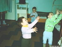 Here the children are playing catch with a soft ball that allows for indoor play, since they can not go outside.