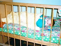 This little girl is more comfortable with her new mattess and blanket.  And thanks to Kenette Newcombe for the crib toys!
