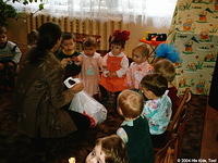 His Kids, Too! director passes out new toys to the children.