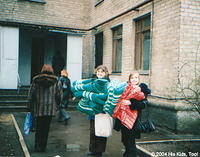 His Kids, Too! board member Lynn, and volunteer Christina help carry in blankets.