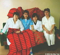 Several workers show off the blankets.