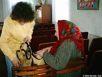 Here, Vita prepares a bag for a waiting widow.