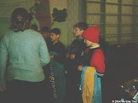 Boys wait patiently while volunteers pass out clothing and personal care products.