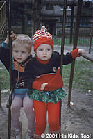 This beautiful girl and boy, though dressed for winter in mid summer, love to swing together!