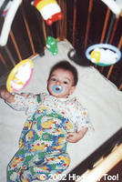 This cutie is mesmerized by his new musical mobile.