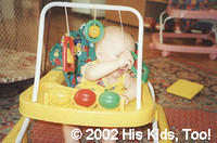 This baby enjoys the new walker, thanks to your donations!