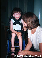 This special child is very thankful to Whitmyer Biomechanix, Inc. for his new mobility. Board member Faye W. looks on