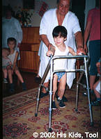 This little one, previously tied to a chair, can now walk with walkers, provided by Joe and Annette Northrop