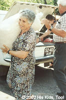 Leza, church member and joyful volunteer carries one of