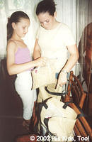 Volunteers Ola and Lydia F. fill one of the 30 widow bags.