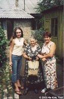 Volunteers present this food bag to this widow.