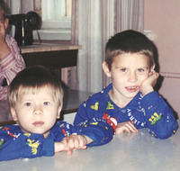 These 2 little boys in blue pose for the camera!
