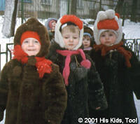 Layered from head to toe, these children are out for fresh air on a cold winter day