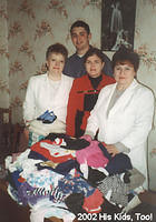 Hospital assistants pictured with 60 lbs. of clothing and 400 surgical gloves to aid the specialized baby hospital.