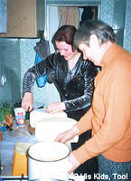 Ladies cut cheese portions for food bags