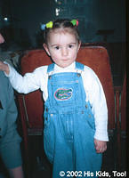 This little girl is happy with her new overalls
